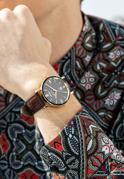 Brown swiss watch for men - watch with brown leather strap and bluedial - all swiss made worn by a man wearing a shirt