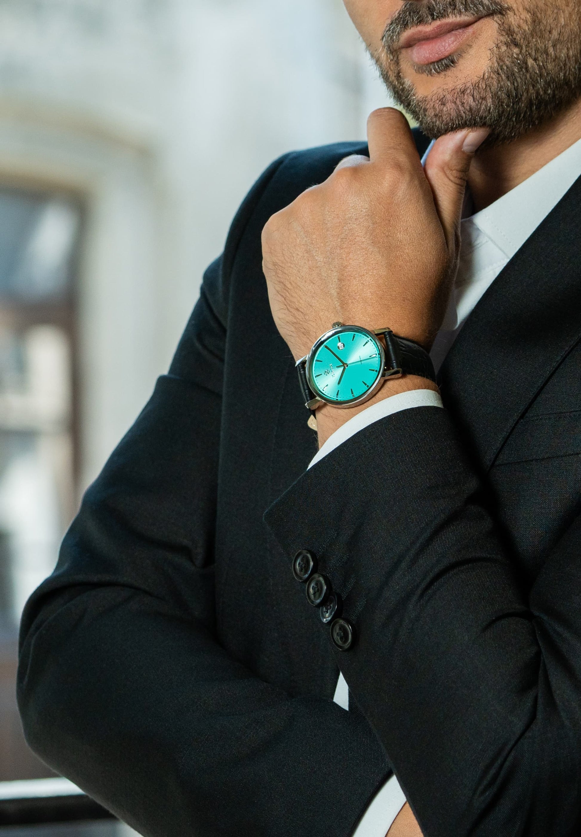 Jowissa Swiss Made Man Watch Magno, blue dial with a leather strap, worn by a black dressed buisnessmen.